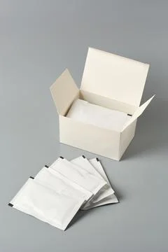 Blank white sachet packets with a box isolated Stock Photos