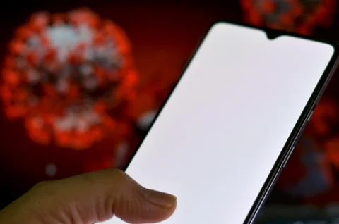 Blank white screen on a mobile in front of a screen illustration of Corona Virus Stock Photos