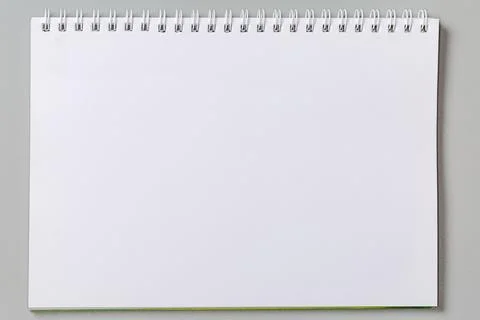 Blank white sheet of exercise book with wire spiral binding Stock Photos