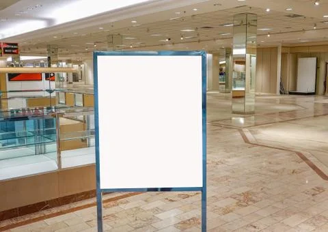 Blank white sign with empty store and showcases in the background Stock Photos