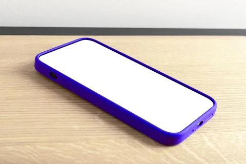 Blank white smartphone screen mockup lying flat on a wooden table. Empty mo.. Stock Photos
