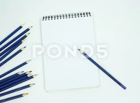 Blank white spiral bound paper drawing pad with color pencil. Isolated on w.. Stock Photos