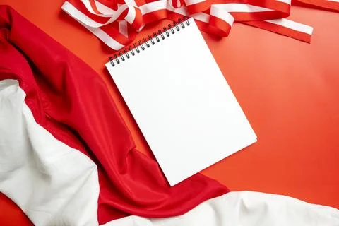 A blank white spiral notepad placed over red and white Indonesian flag fabr.. Stock Photos