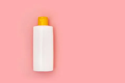 Blank white squeeze bottle plastic tube on pink background copy space Stock Photos