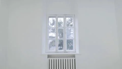 Blank white wall with window. Slide motion of movement or hitting the camera on Foto stock