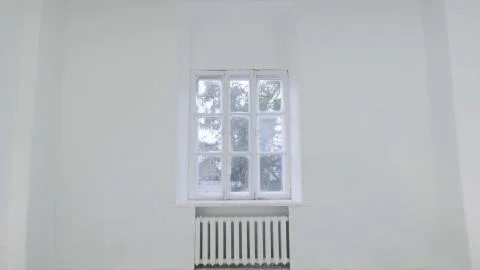 Blank white wall with window. Slide motion of movement or hitting the camera on Foto stock