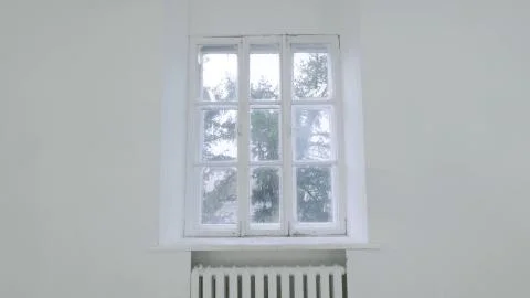 Blank white wall with window. Slide motion of movement or hitting the camera on Foto stock