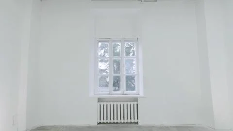 Blank white wall with window. Slide motion of movement or hitting the camera on Foto stock