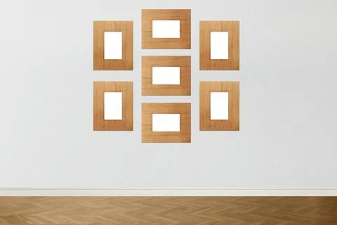 Blank wooden frames hanging on light gray wall. Mockup for design Stock Photos