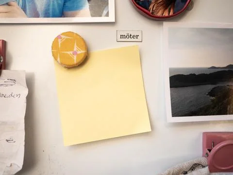 Blank Yellow Note on Refrigerator Surrounded by more Magnets and Notes Stock Photos
