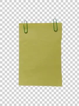Blank yellow paper note held by two green paper clips Фото