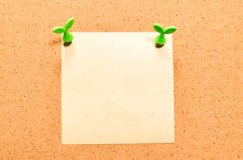 Blank yellow square note paper on cork board with leaf pin Stock Photos