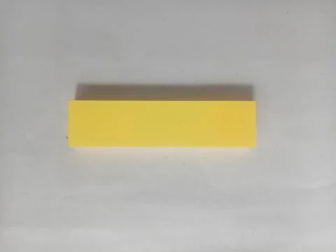 Blank Yellow Sticky Note Page on Plain White Background with Copy Space Stock Photos