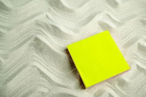 Blank yellow sticky note on textured wavy white sand, providing copy space... Stock Photos
