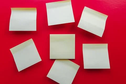 Blank yellow sticky notes on a red background, business work concept. Yellow  Stock-Fotos