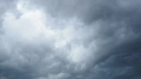 A blanket of dark clouds envelops the skyline, signaling an impending storm. The Stock Footage 297022030