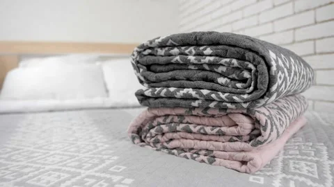 Blanket folded on bed in bright apartment Stock Footage 282365631