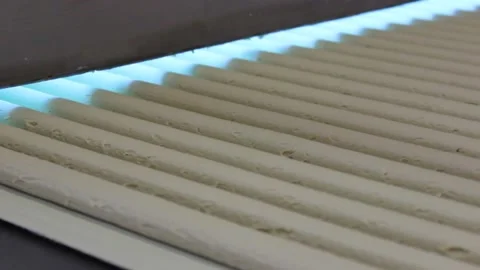 Blanks from the mixture for making sweet bars move along the conveyor belt Stock Footage 128643008