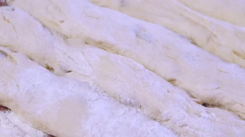 Blanks for Shabbat challah bread in flour on a wooden table Stock Footage 210542595