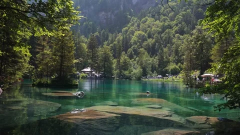 BLAUSEE, SWITZERLAND: Crystal-clear turquoise alpine lake  (June, 2025) Stock Footage 343855876