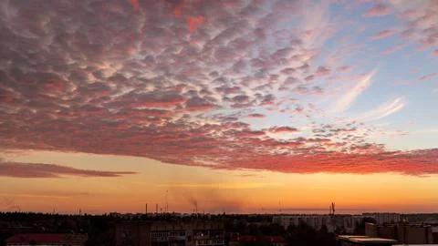 Blazing clouds against the backdrop of the setting sun Stock Photos