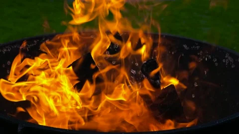 Blazing fire burning in a metal fire pit Stock Footage 337869499