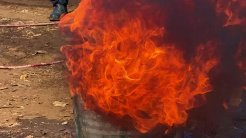 Blazing fire consuming metal drum with intense flames rising. Video stock 341458449