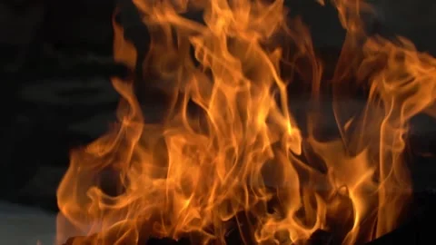 A blazing fire in the dark in a fireplace or stove. Ignition of wood Stock Footage 153577702