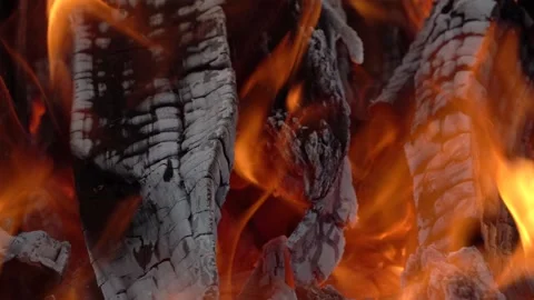 A blazing fire in the dark in a fireplace or stove. Ignition of wood in the Stock Footage 154136396