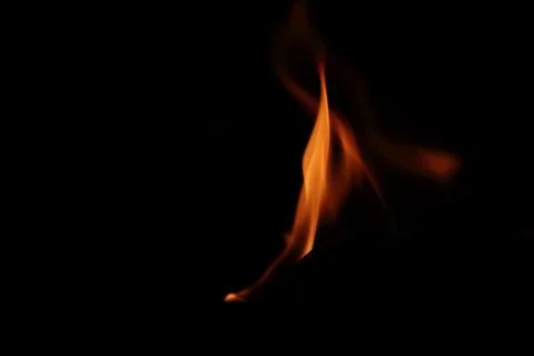 A blazing flame of fire on a black background Stock Photos
