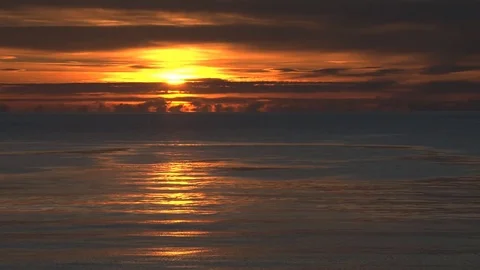 Blazing sun setting over ocean Stock Footage 74062427