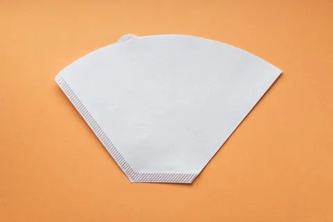 Bleached paper coffee filter for immersion brewing isolated on a colored pink Stock Photos