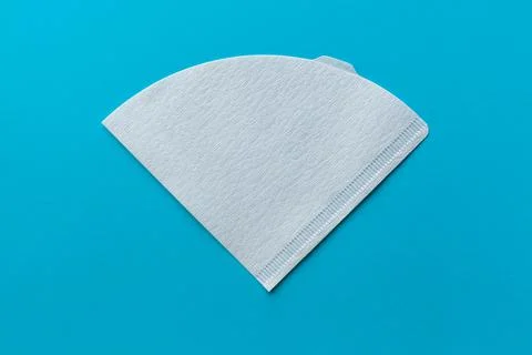 Bleached paper coffee filter isolated on blue background Stock Photos