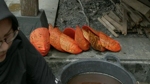 Bleaching a traditional java wooden mask Stock Footage 259789613