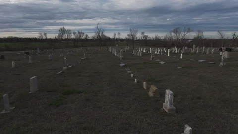 Bleak, gloomy scenery of an empty, rural gravesite. No people are visiting. Stock Footage 308793996