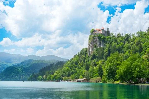 Bled Castle on cliff above Lake Bled surrounded by forest Stock Photos