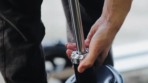 Bleeding air into new car shock absorbers before installation. Stock Footage 139167533
