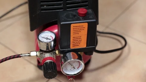 Bleeding of air from the receiver of the compressor, close up view at hand Stock Footage 87042347