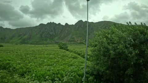 Bleik road sign intersection and jagged green mountains in Andoya Norway Stock-Footage 343131151