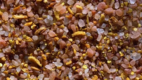 A blend of Himalayan pink salt with garlic and pepper rotates on the turntable Stock Footage 170628778