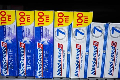 Blend-a-med toothpaste packages displayed in a retail store shelf setting Stock Photos