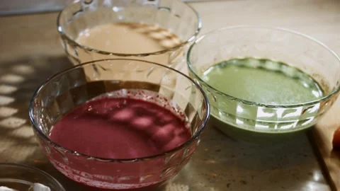 Blend pancake batter and fresh spinach leaves, rubbed carrot and rubbed beet in Stock Footage 144904090