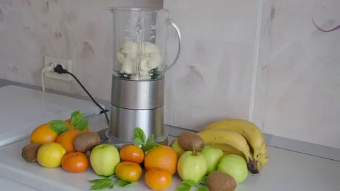 Blender and fruit on the kitchen table. Cooking Stock Footage 104873922
