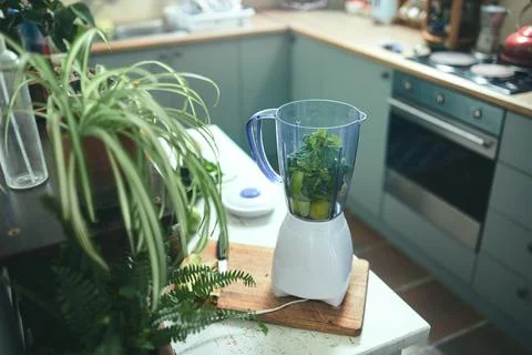 Blender in kitchen with greens Stock Photos