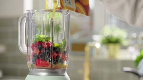 Blender making fruit smoothy Stock Footage 254584515