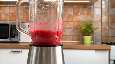 Blender with red currant smoothie working on the kitchen Stock Footage 115340139