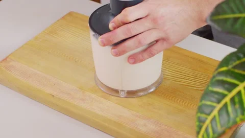 Blending all milkshake ingredients in a blender cup. Vídeo Stock 312720448