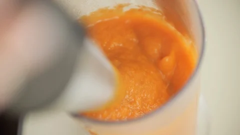 Blending boiled pumpkin to make healthy vegetarian soup Stock Footage 101922194