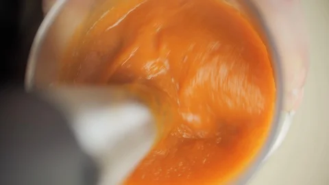 Blending boiled pumpkin to make healthy vegetarian soup Stock Footage 101922279