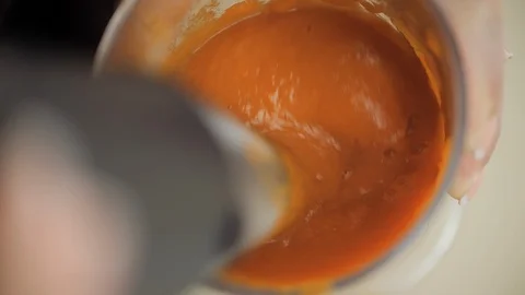 Blending boiled pumpkin to make healthy vegetarian soup. POV Stock Footage 102134366